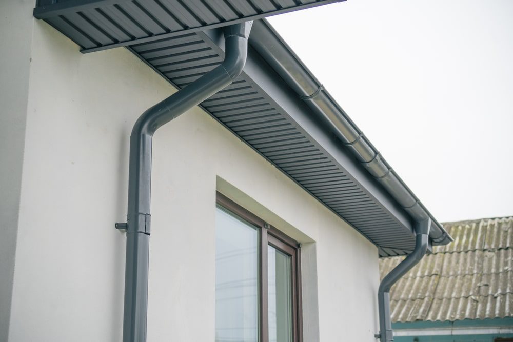 Gray rain gutter system on house exterior