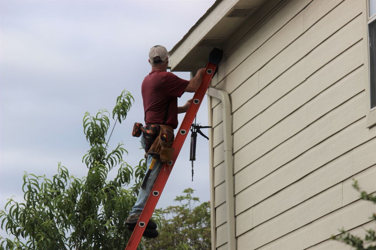 Worker installing new gutter system in Reno, Nevada