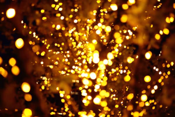 Abstract golden bokeh lights in dark background