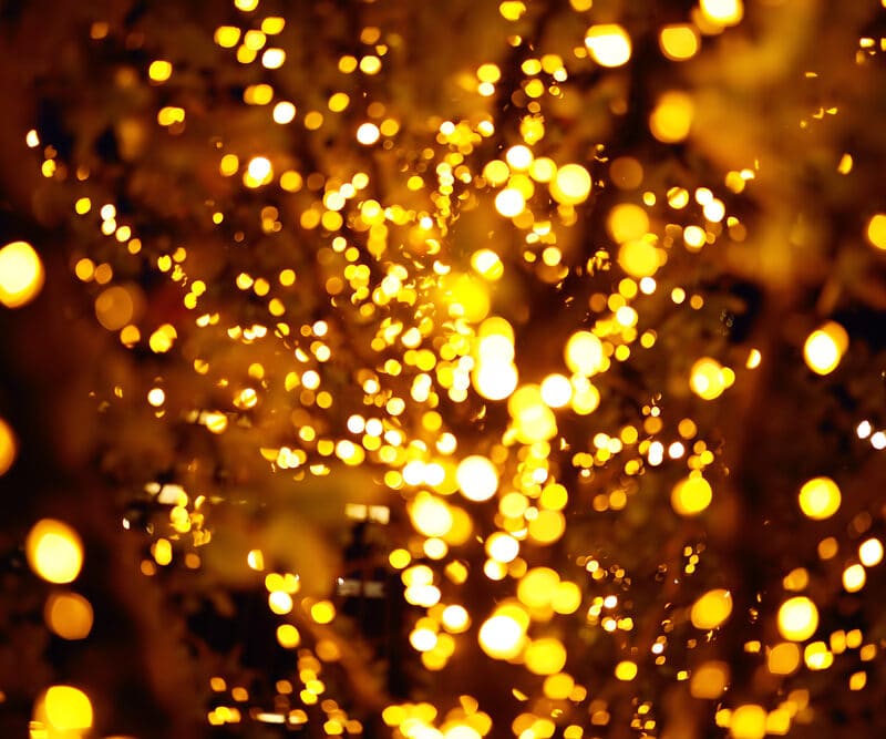 Abstract golden bokeh lights in dark background